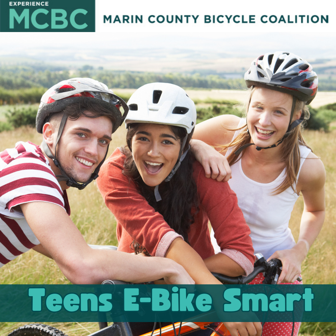Three teens with helmets and bikes smiling