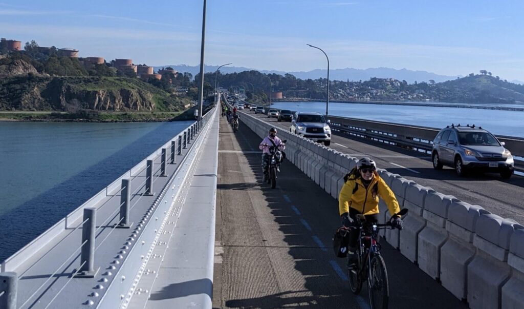 woman on a bike on the Richmond-San Rafael Bridge