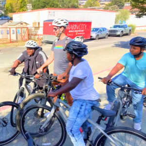 Three Cory's Ride students on bikes with adult on bike