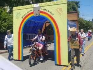 Dad riding through tunnel float with kid on cargo bike