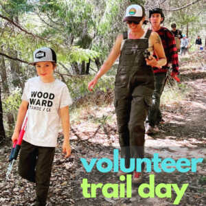 Child with cutters and 2 adults on trail for volunteer trail day