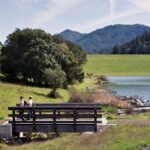 image of new bridge on Liberty Gulch Trail on Azalea Hill with 2 people walking across