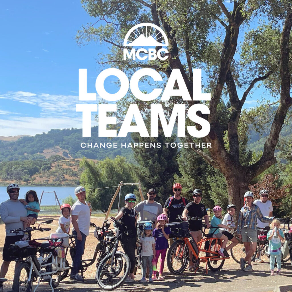 Group of families with bikes and Local Teams Logo
