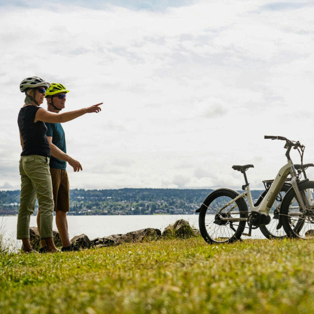 two people with ebikes pointing