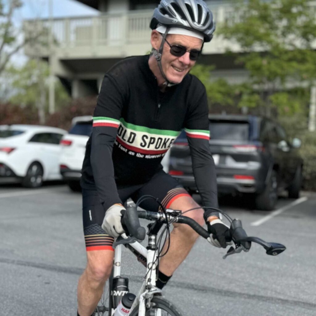 Chuck Ford riding a bike in black Old Spokes jersey