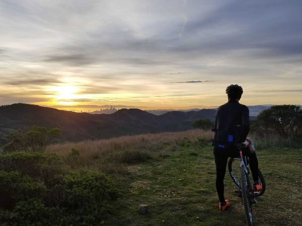 biker looking at sunset