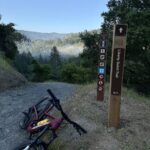 Bike laying down beside new liberty gulch trail sign on Mt. Tam Watershed