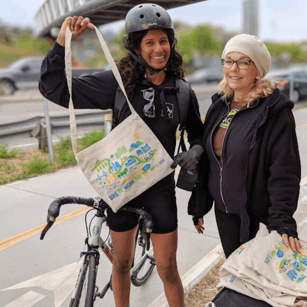 woman holding up a bike to work day bag at Larkspur landing energizer station