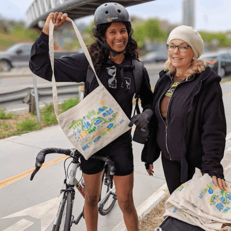 woman holding up a bike to work day bag at Larkspur landing energizer station