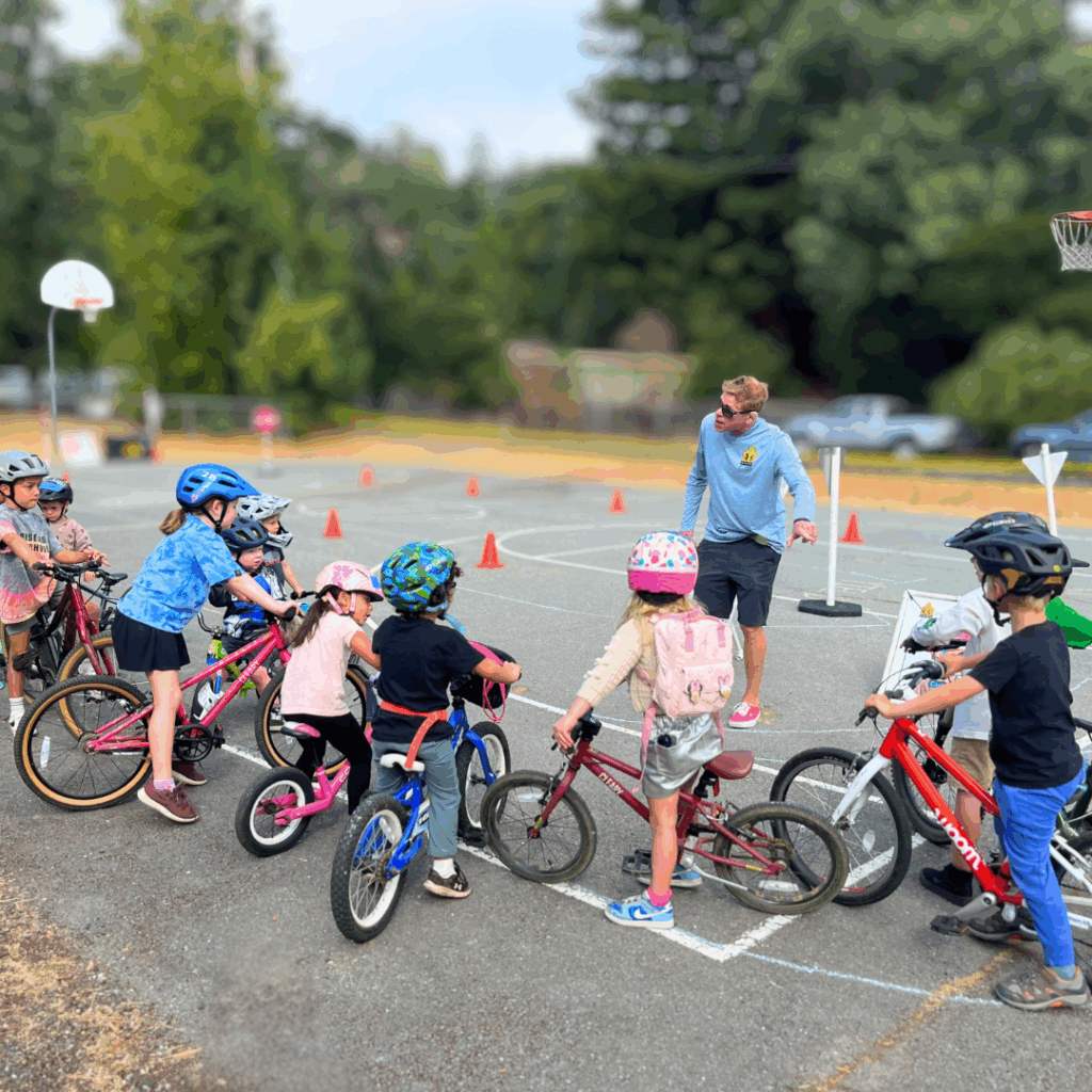 small kids with bikes and instructor at a learn-to-bike rodeo class