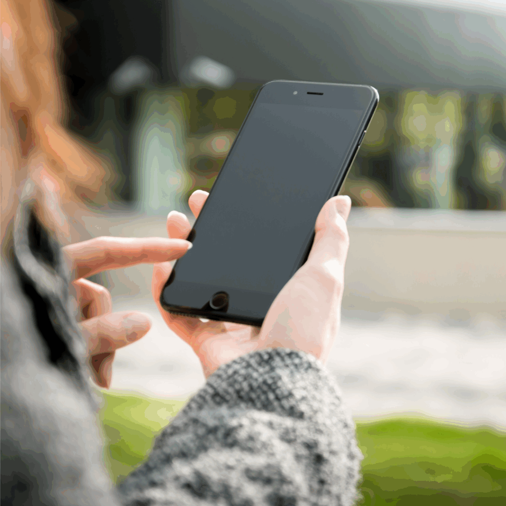 person holding a phone about to call with blurred background